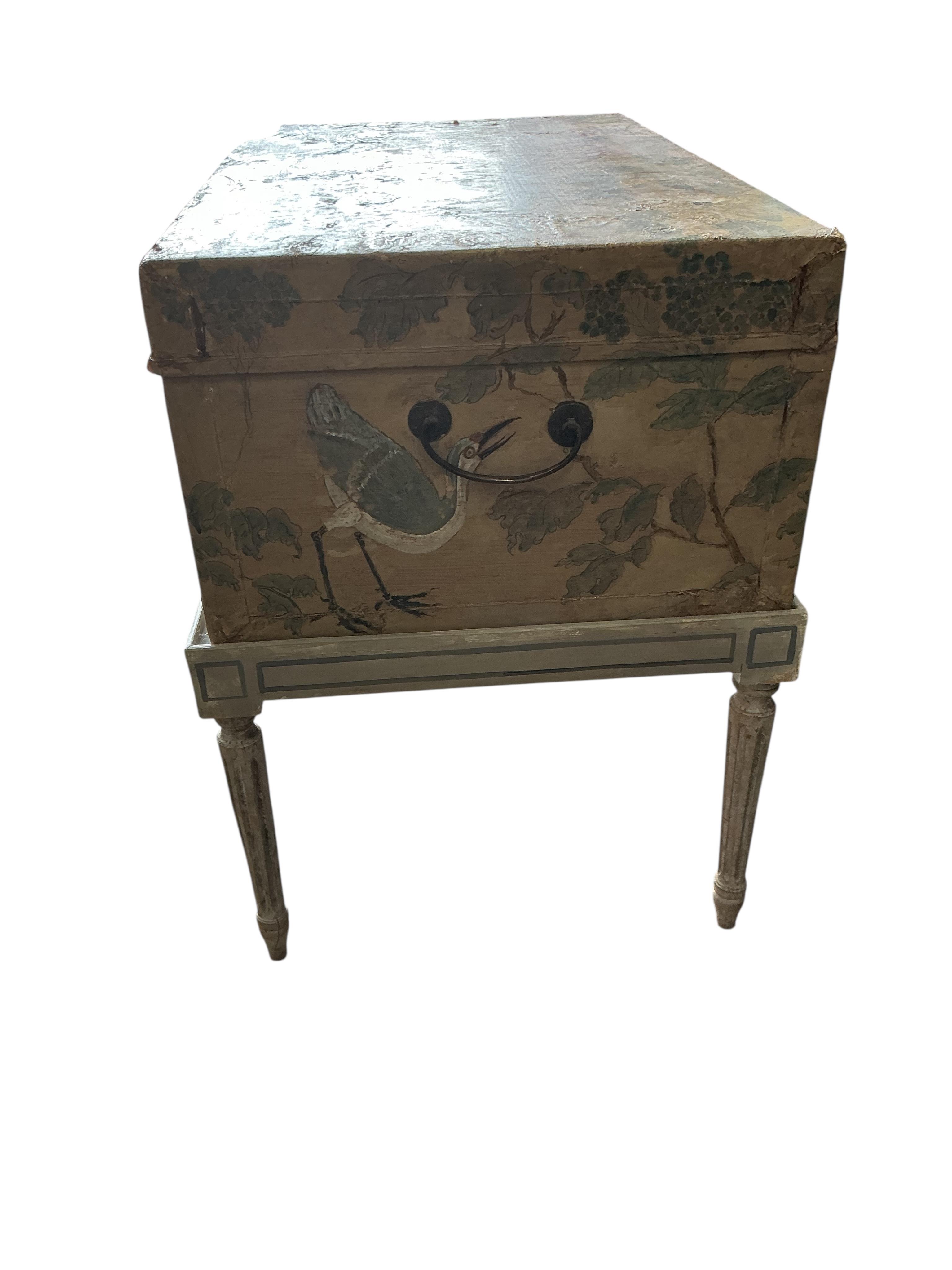 A Chinese painted hide chest on a cream painted parcel gilt stand, width 77cm, depth 50cm, height 67cm
